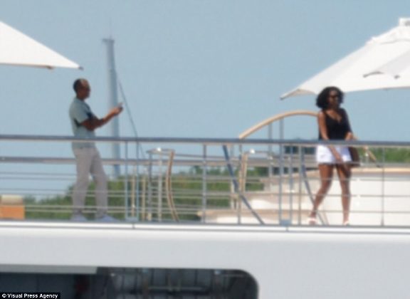 Barack Obama spotted taking photos of his wife Michelle aboard a yacht