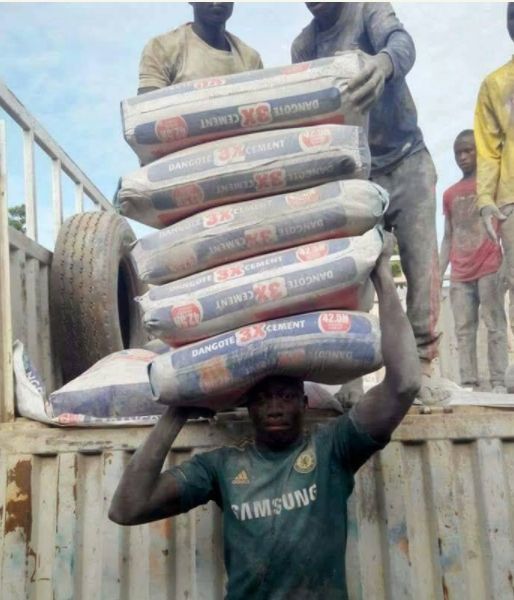 Man Carrying 5 Bags Of Cement On His Head?