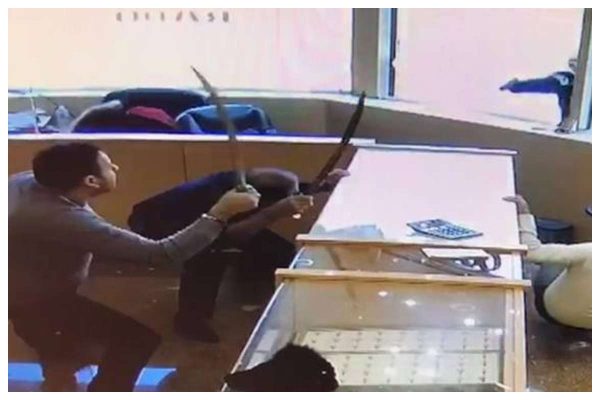 Jewellery shop employees fight off gun wielding robbers with swords