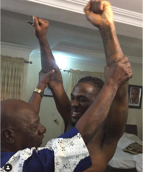 Viral photo of Burna Boy’s grandfather who used to manage Fela showing him how to properly do his signature pose
